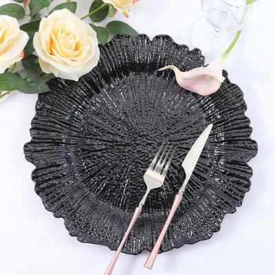 Black decorative plate with rose gold cutlery and floral accents.