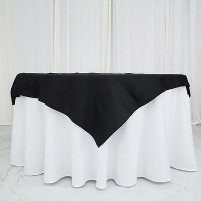 Black tablecloth draped over a white table for elegant dining settings.