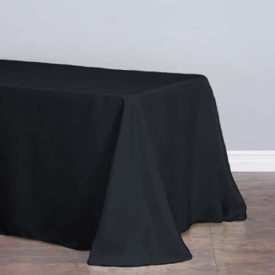 Black tablecloth draped elegantly over a table on a neutral background.