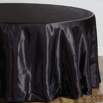 Black satin tablecloth draping elegantly over a round table.