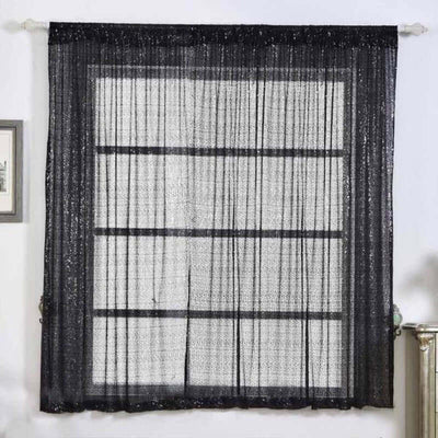 Black sheer curtains with a textured pattern, elegantly draping a window.