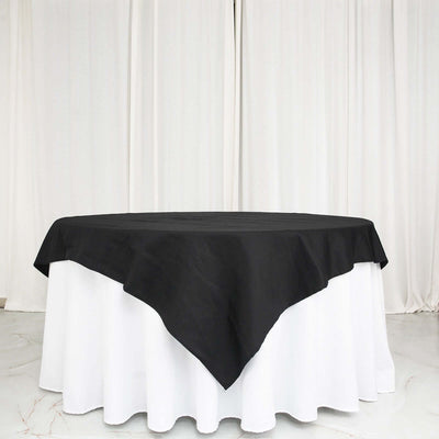 Black tablecloth draped over white table for elegant dining settings.