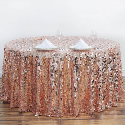 Rose gold sequin tablecloth draped on a round table for elegant decor.