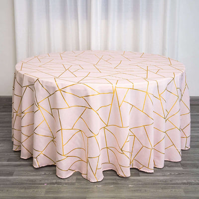 Round tablecloth with geometric gold and pink design.
