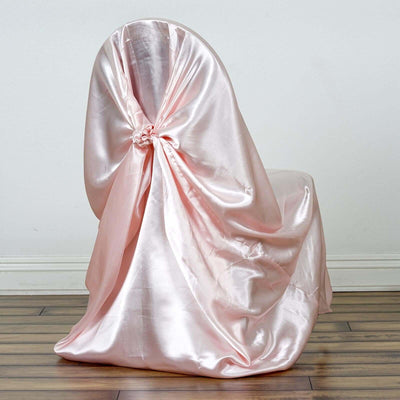Pink satin chair cover draped elegantly on a chair.