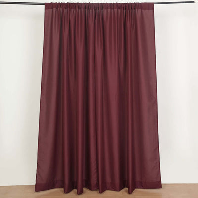 Burgundy sheer curtain panel hanging from a rod