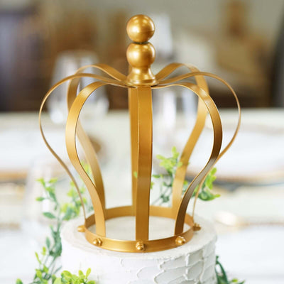 Gold crown cake topper with elegant design and floral accents.
