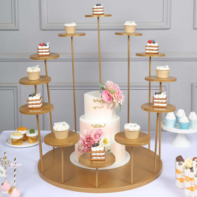 Elegant dessert display with cupcakes and a decorated cake on a tiered stand.