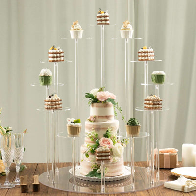 Elegant multi-tiered cake display with assorted cupcakes and floral accents.