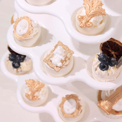 Decorative dessert display with intricate toppings on a tiered stand.