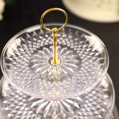 Elegant two-tiered crystal cake stand with gold handle.