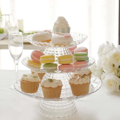 Tiered dessert stand with colorful macarons and cupcakes.