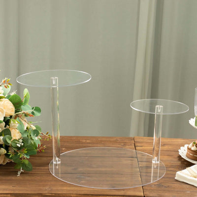 Acrylic cake stand set with two tiers on a wooden table.