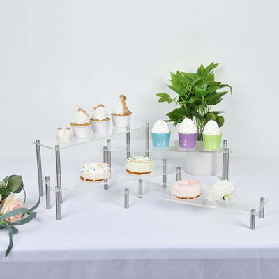 Display stand with desserts and plants on a clear acrylic design.