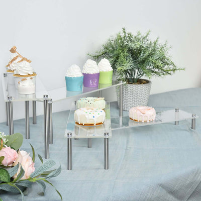 Decorative dessert display with cupcakes and ice cream on clear acrylic stands.
