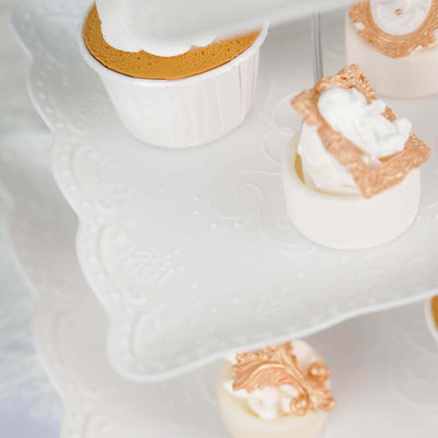 Elegant dessert display featuring various decorated cupcakes on a tiered stand.