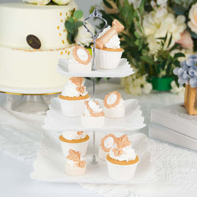 Decorative cupcake stand with elegant cupcakes and frosting.