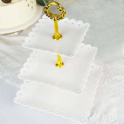 Three-tiered white serving stand with gold handle