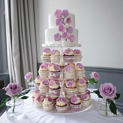 Elegant cupcake tower with lavender flowers and a two-tier cake.