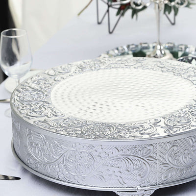 Silver ornate cake stand with intricate detailing.