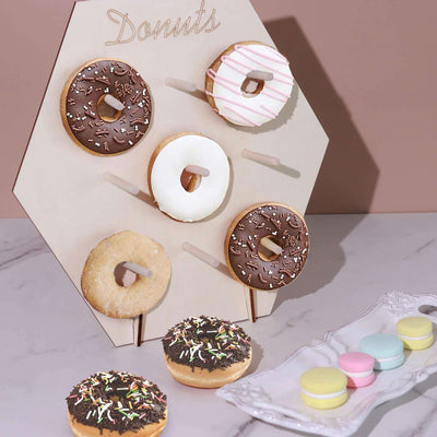Donuts on display with assorted flavors and colors in a stylish setting.