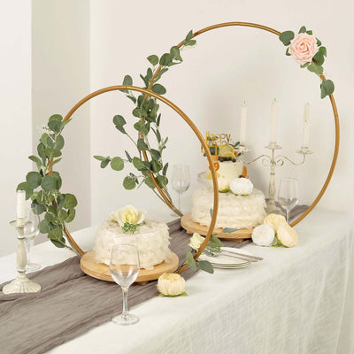 Elegant wedding cake display with floral accents and decorative rings.