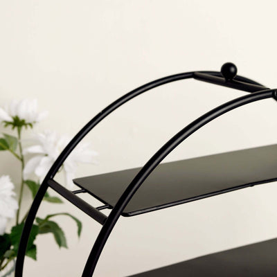 Black metal shelving unit with curved design and three shelves.