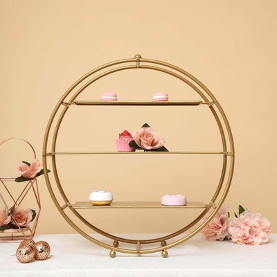 Gold circular shelf with desserts and flowers, set against a soft beige background.