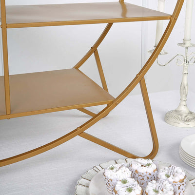 Gold metal shelving unit with curved design and two shelves.