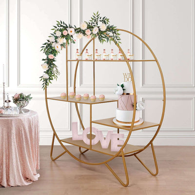 Gold circular display stand with floral decor and wedding cake, perfect for events.