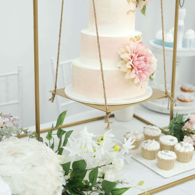 Three-tiered wedding cake with pink accents and floral decorations on a display stand.