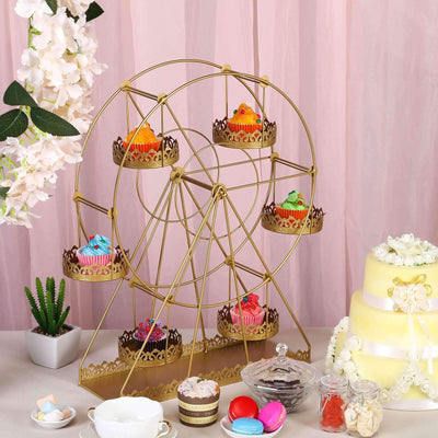 Colorful cupcakes displayed on a decorative ferris wheel stand at a festive event.