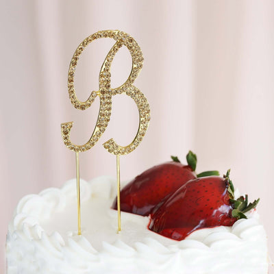 Gold glitter "B" cake topper adorned with strawberries.
