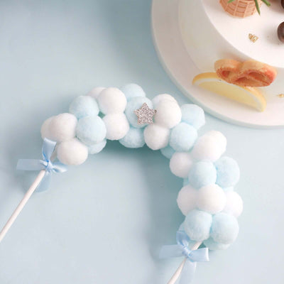 Blue and white pom pom cloud decoration with glitter star accent.