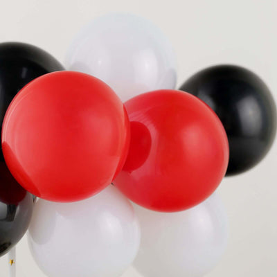 Colorful balloons in red, black, and white arranged together.