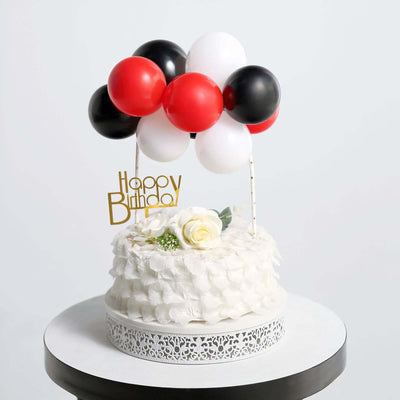 Birthday cake with balloons and decorative elements on a white background.
