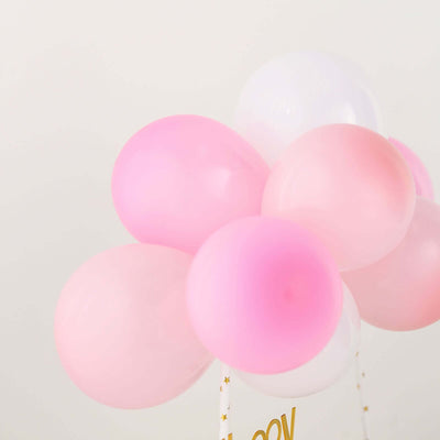 Pink and white balloons arranged together for a festive celebration