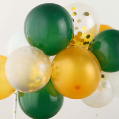 Colorful balloons in green, gold, and clear with confetti.