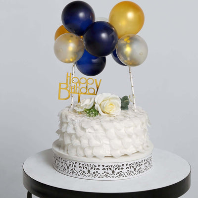 Birthday cake with balloons and decorations on a white backdrop