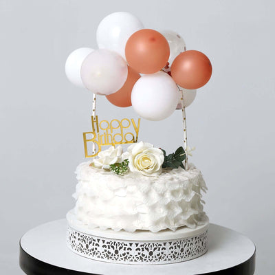 Birthday cake with balloons and a "Happy Birthday" topper on a white background.