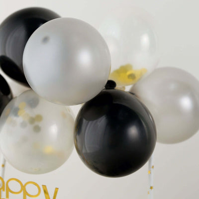 Black and silver party balloons with confetti accents
