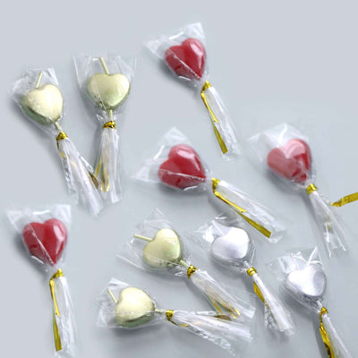 Colorful heart-shaped candies wrapped in clear packaging.