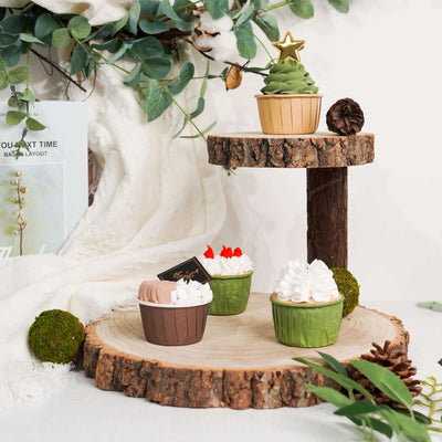 Decorative cupcakes on a rustic wooden display with greenery accents.