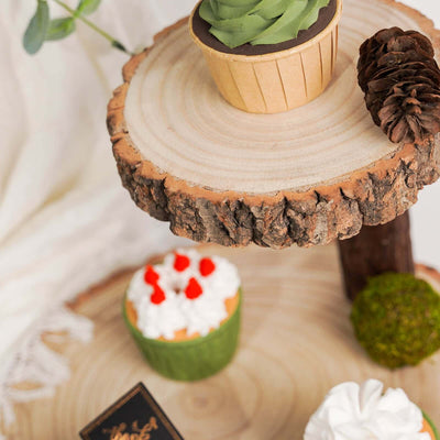 Decorative cupcakes on a rustic wooden stand with greenery accents.
