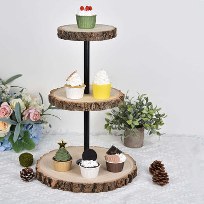 Decorative cupcake stand with assorted cupcakes and greenery accents.