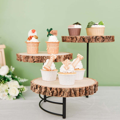 Decorative cupcakes displayed on wooden stands against a green background.