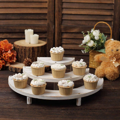 Decorative cupcakes on a wooden display with flowers and a teddy bear.