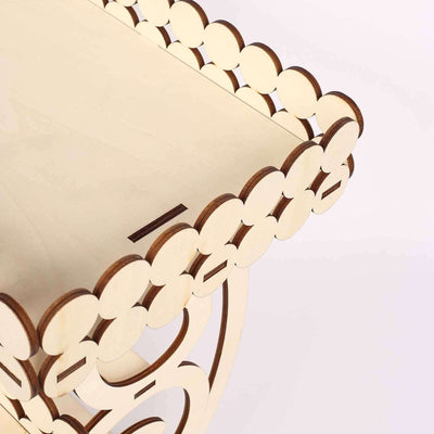 Decorative wooden table with scalloped edges against a plain background.