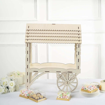 Decorative wooden cart for events with pastel candies on a table