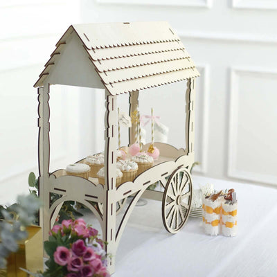 Wooden dessert cart display with cupcakes and decorations.